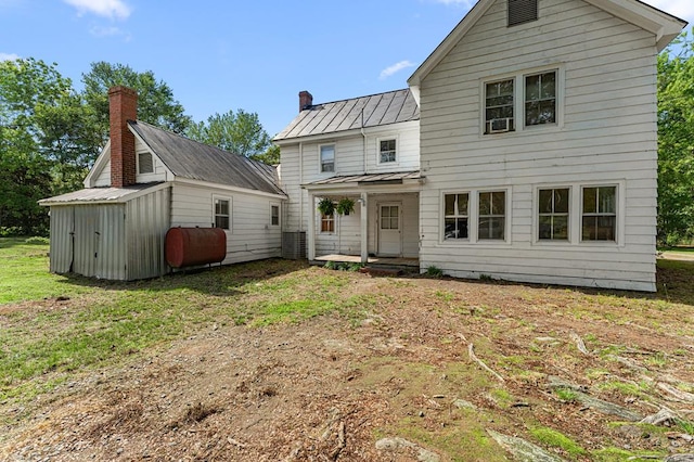 1838 Muddy Gut Rd, Dunnsville, VA 22454 - back of property with heating fuel, a standing seam roof, a shed, a yard, and a metal roof