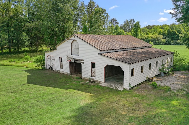 1838 Muddy Gut Rd, Dunnsville, VA 22454 - view of home's exterior with a barn, a lawn, an outbuilding, a garage, and metal roof