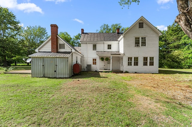 1838 Muddy Gut Rd, Dunnsville, VA 22454 - rear view of property featuring a yard, a shed, a chimney, and a shingled roof