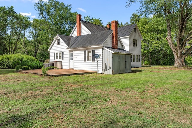 1838 Muddy Gut Rd, Dunnsville, VA 22454 - back of house featuring a metal roof, a wooden deck, a shed, and a yard