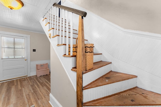 1838 Muddy Gut Rd, Dunnsville, VA 22454 - stairway featuring wood finished floors, a wainscoted wall, and ornamental molding
