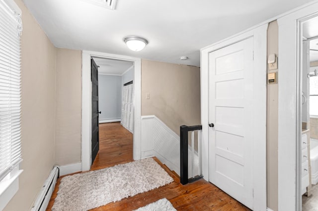 1838 Muddy Gut Rd, Dunnsville, VA 22454 - foyer entrance featuring wood finished floors, a baseboard radiator, baseboard heating, and wainscoting