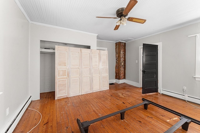 1838 Muddy Gut Rd, Dunnsville, VA 22454 - unfurnished bedroom featuring a baseboard heating unit, hardwood / wood-style floors, crown molding, and a ceiling fan