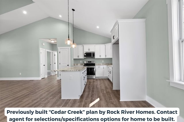 kitchen with appliances with stainless steel finishes, pendant lighting, white cabinetry, a center island, and light stone counters