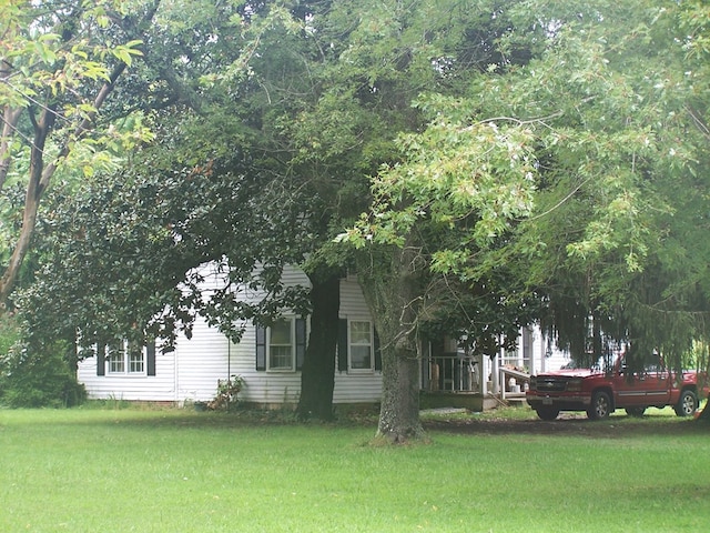 view of property exterior with a yard