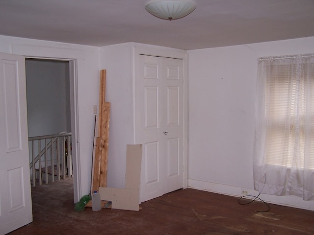 unfurnished bedroom with dark hardwood / wood-style floors