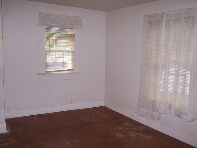 unfurnished room featuring dark wood-type flooring