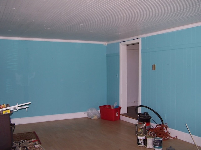 interior space with crown molding and wood-type flooring