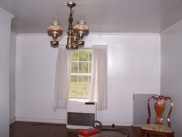 dining area with dark wood-type flooring, a notable chandelier, crown molding, and a wealth of natural light