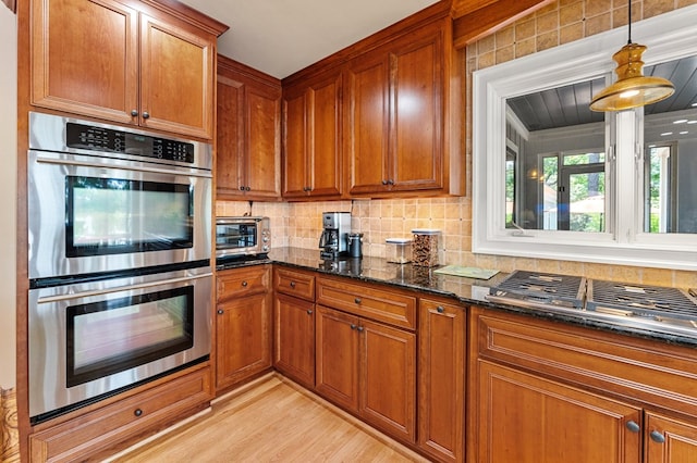 873 Deep Creek Rd, Lancaster, VA 22503 - kitchen with stainless steel appliances, brown cabinetry, and dark stone countertops