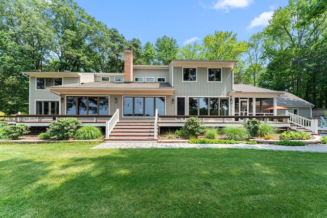 873 Deep Creek Rd, Lancaster, VA 22503 - back of house featuring a sunroom, a wooden deck, a chimney, and a yard
