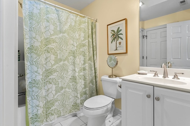 bathroom featuring tile patterned flooring, vanity, and toilet