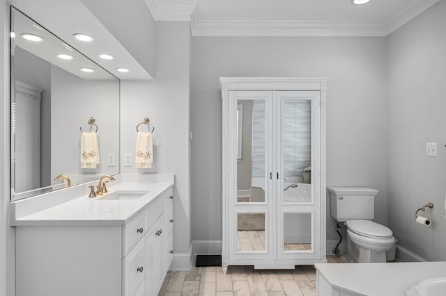 bathroom with crown molding, vanity, and toilet