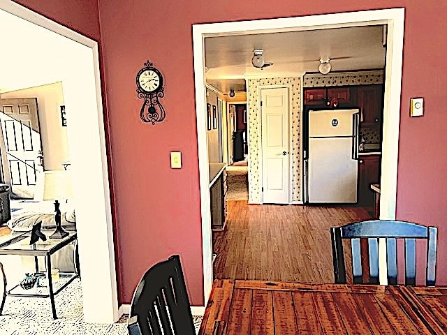 corridor with hardwood / wood-style floors