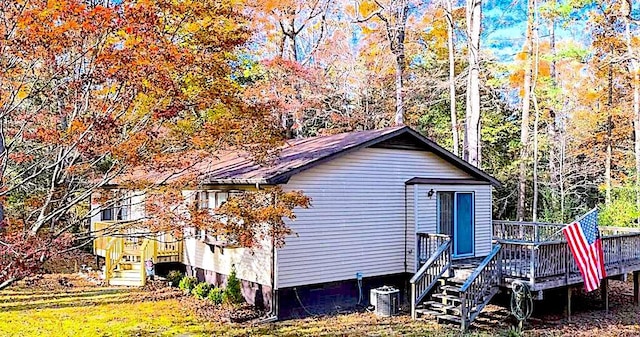 view of side of property featuring a wooden deck and central air condition unit