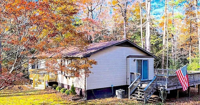 exterior space featuring cooling unit and a wooden deck