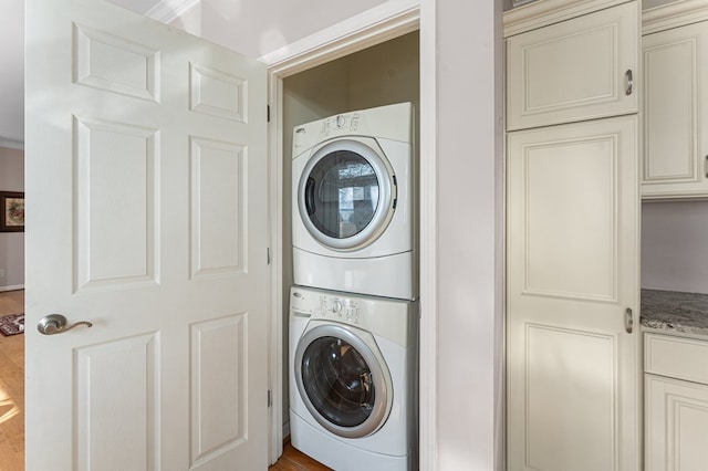 laundry area featuring laundry area and stacked washing maching and dryer