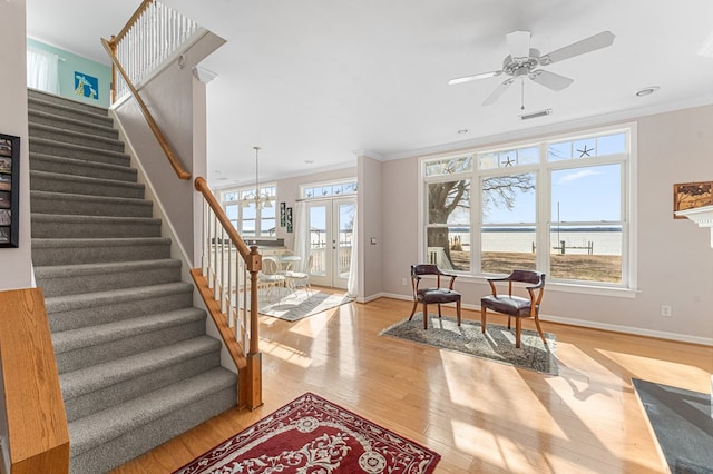 interior space featuring stairway, visible vents, light wood-style flooring, french doors, and crown molding