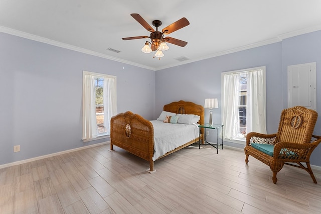 bedroom with visible vents, crown molding, and light wood-style floors