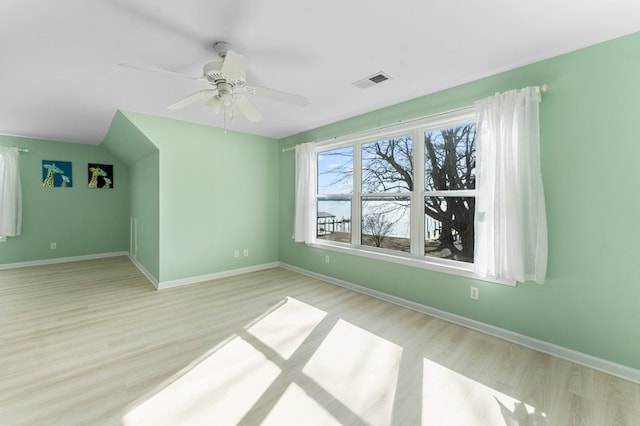 unfurnished room featuring visible vents, baseboards, wood finished floors, and a ceiling fan