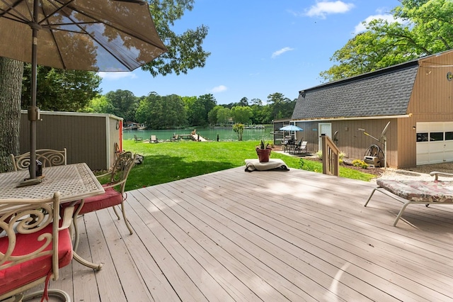 844 Monarch Shores Rd, Kilmarnock, VA 22482 - deck featuring outdoor dining space, an outbuilding, a yard, and a water view