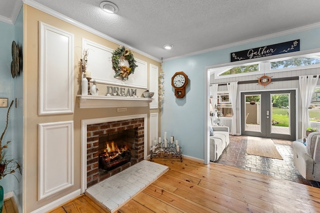844 Monarch Shores Rd, Kilmarnock, VA 22482 - foyer with a fireplace, ornamental molding, a textured ceiling, light wood-style flooring, and french doors