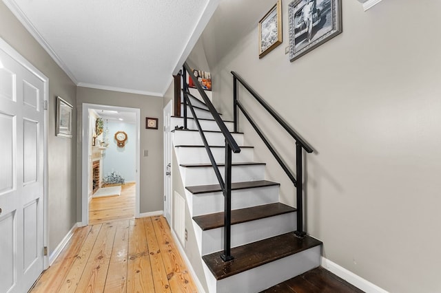 844 Monarch Shores Rd, Kilmarnock, VA 22482 - staircase featuring hardwood / wood-style flooring, baseboards, and ornamental molding