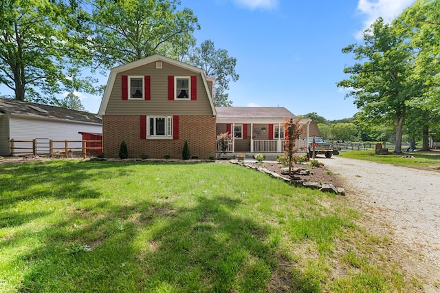 844 Monarch Shores Rd, Kilmarnock, VA 22482 - colonial inspired home with a gambrel roof, brick siding, and driveway