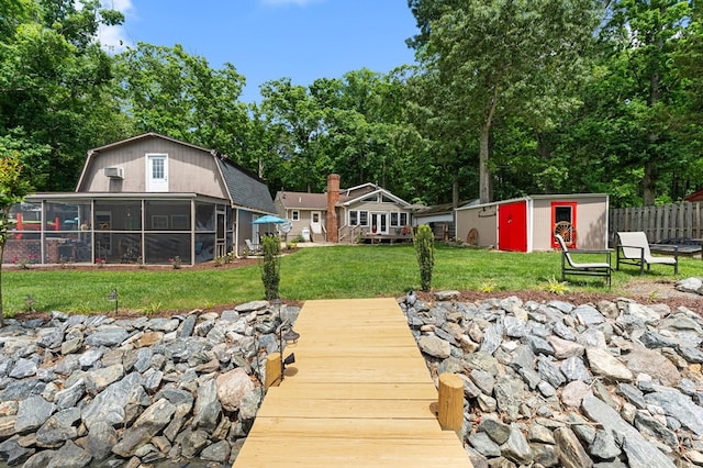 844 Monarch Shores Rd, Kilmarnock, VA 22482 - back of property with a sunroom, a gambrel roof, and an outbuilding