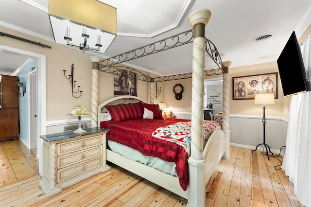 844 Monarch Shores Rd, Kilmarnock, VA 22482 - bedroom with light wood-type flooring, ornamental molding, and wainscoting