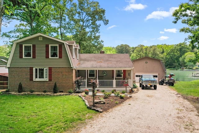 844 Monarch Shores Rd, Kilmarnock, VA 22482 - colonial inspired home with a porch, a gambrel roof, a detached garage, a front lawn, and an outbuilding