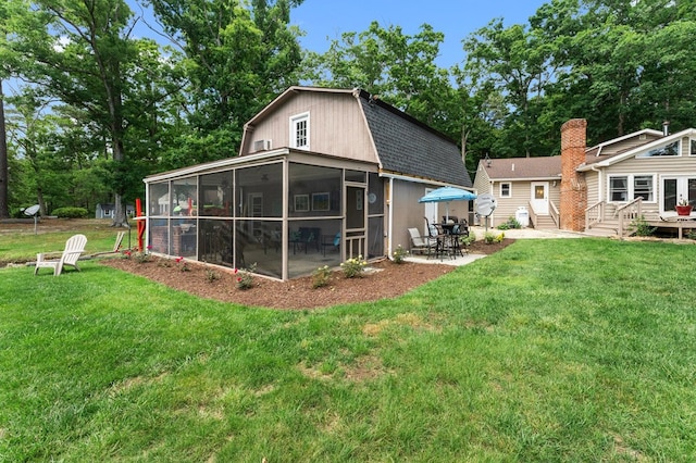 844 Monarch Shores Rd, Kilmarnock, VA 22482 - rear view of property with a sunroom, a gambrel roof, a yard, and roof with shingles