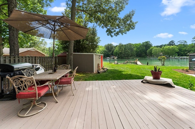 844 Monarch Shores Rd, Kilmarnock, VA 22482 - wooden terrace with a water view, outdoor dining area, a shed, and an outbuilding