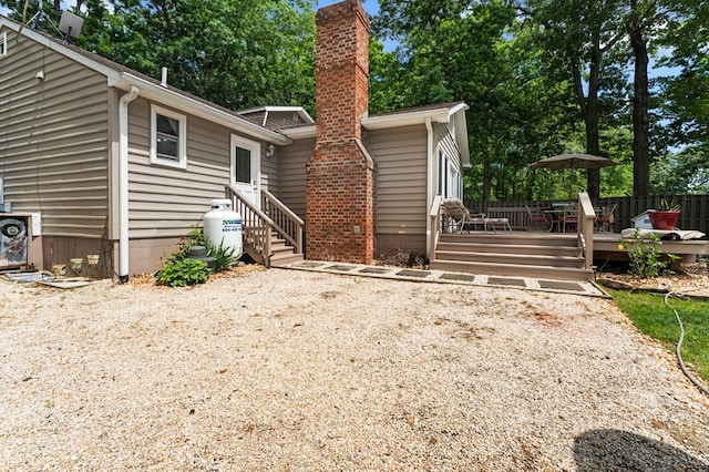 844 Monarch Shores Rd, Kilmarnock, VA 22482 - back of house featuring a wooden deck and a chimney