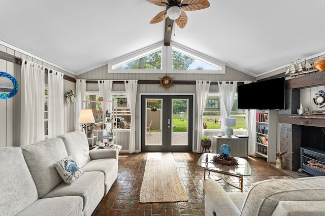 844 Monarch Shores Rd, Kilmarnock, VA 22482 - living room with a ceiling fan, lofted ceiling, a fireplace, french doors, and brick floors
