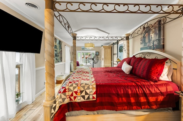 844 Monarch Shores Rd, Kilmarnock, VA 22482 - bedroom with wood finished floors and crown molding