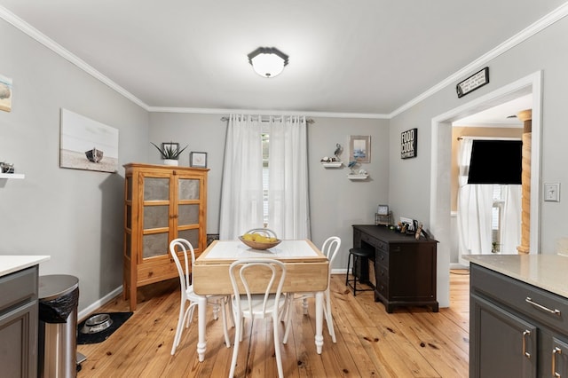 844 Monarch Shores Rd, Kilmarnock, VA 22482 - dining area with crown molding, light wood-style floors, and baseboards
