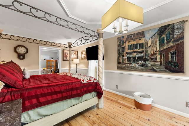 844 Monarch Shores Rd, Kilmarnock, VA 22482 - bedroom with hardwood / wood-style floors, ornamental molding, and a chandelier