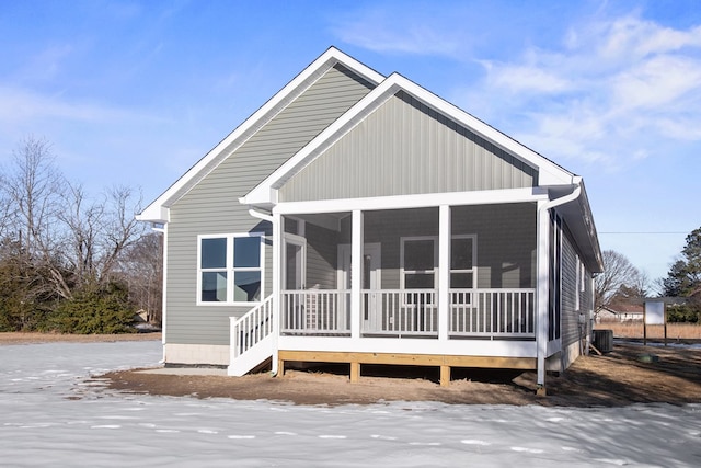 back of property featuring a sunroom and central air condition unit