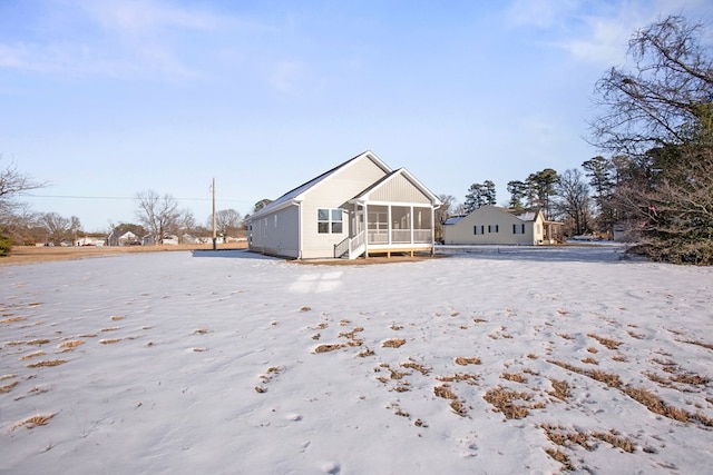 rear view of property with a sunroom