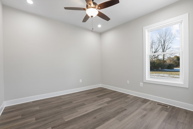 unfurnished room with ceiling fan and dark hardwood / wood-style flooring