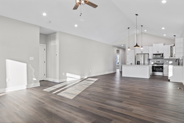 unfurnished living room with ceiling fan, dark hardwood / wood-style flooring, sink, and high vaulted ceiling