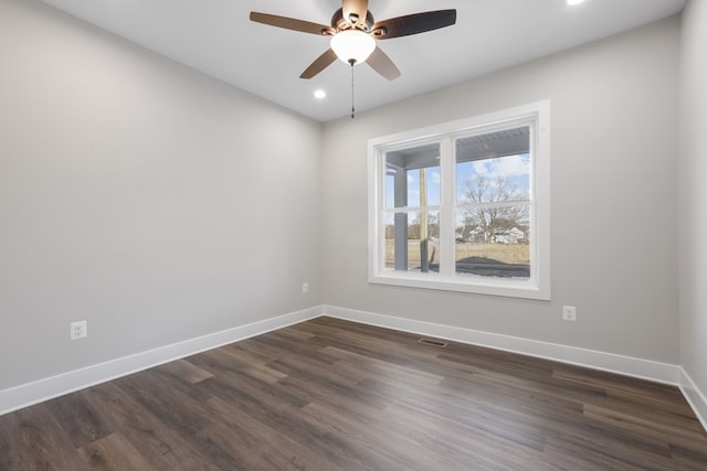 unfurnished room featuring ceiling fan and dark hardwood / wood-style flooring