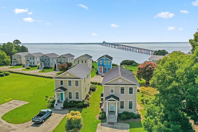 drone / aerial view with a residential view and a water view