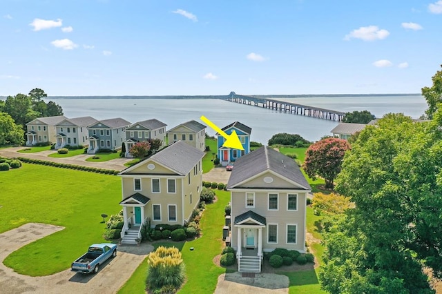 drone / aerial view with a water view and a residential view