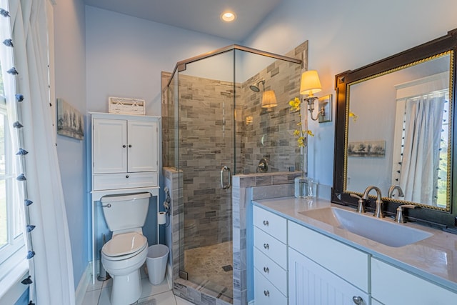 bathroom with tile patterned flooring, vanity, toilet, and an enclosed shower