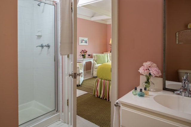 bathroom with a shower with door, vanity, and toilet