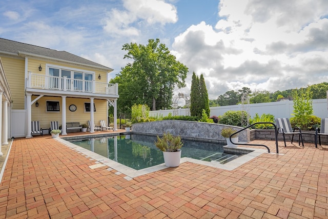 view of swimming pool with an outdoor living space and a patio