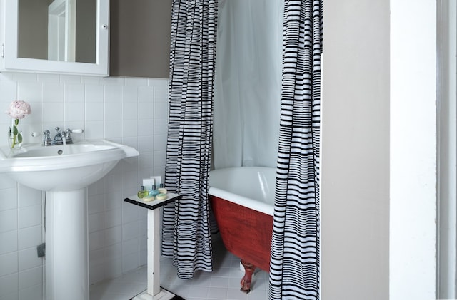 bathroom with tile patterned floors and tile walls