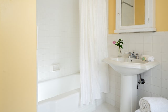 bathroom with shower / bath combination with curtain